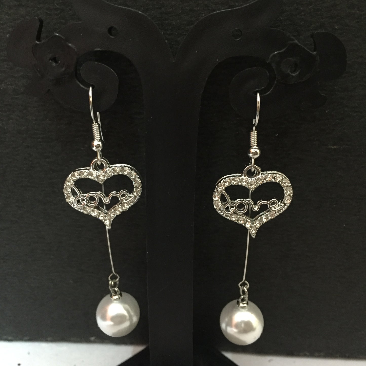 Heart-shaped crystal dangler earrings with ‘love’ design and pearl drop – stylish fashion jewellery