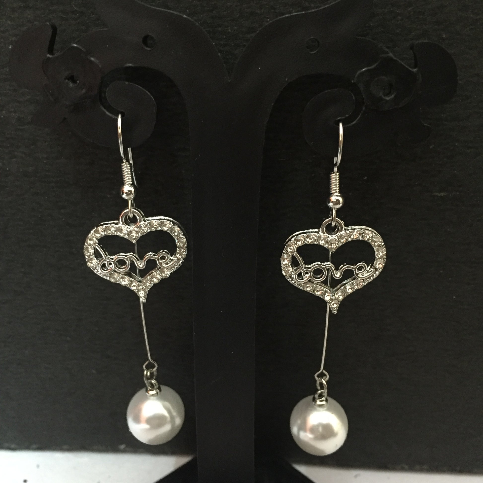 Heart-shaped crystal dangler earrings with ‘love’ design and pearl drop – stylish fashion jewellery